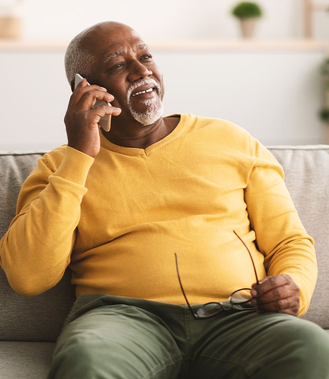Older black man talking on the phone