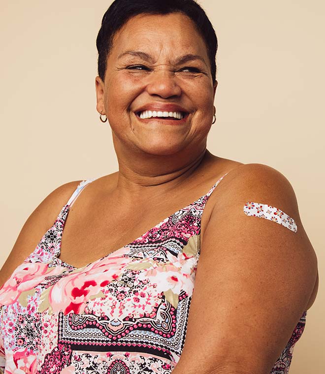Happy older woman smiling with a bandage on her arm