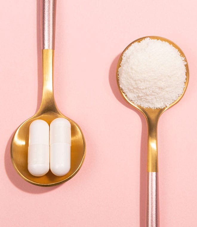 One spoon holding two pills and one spoon holding powder