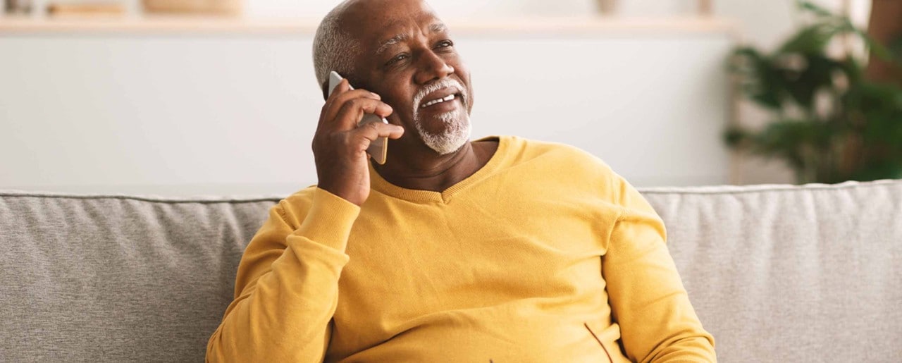 Older black man talking on the phone