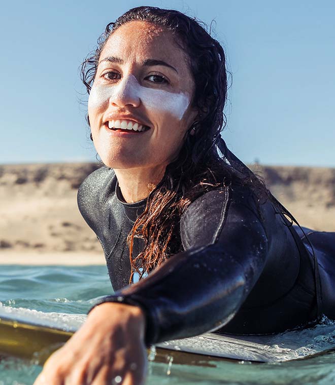 Female surfer with sunscreen across her nose