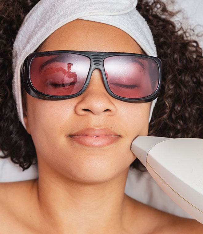 Young black woman getting laser treatment on her face