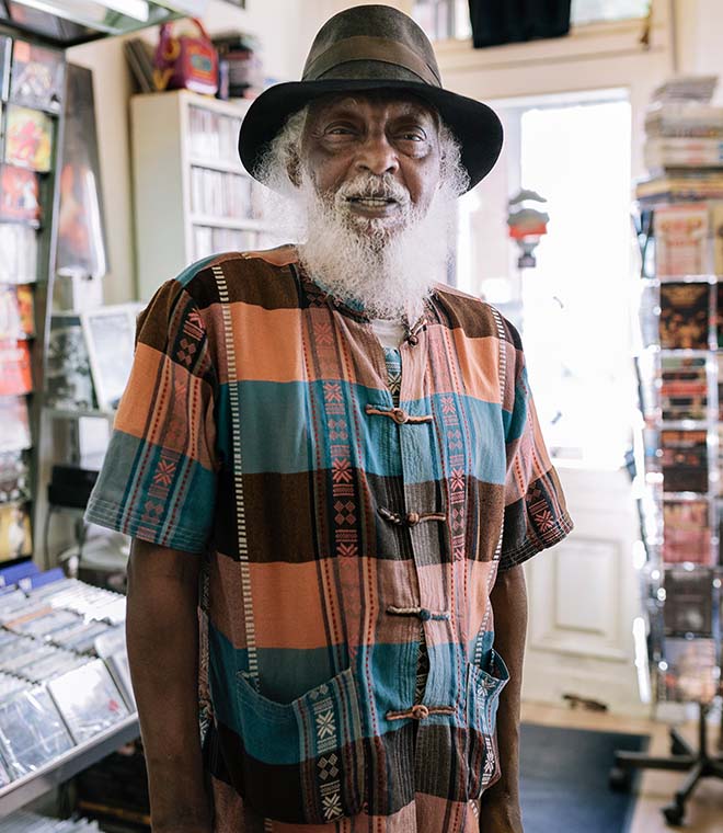 Older black man smiling in a record store