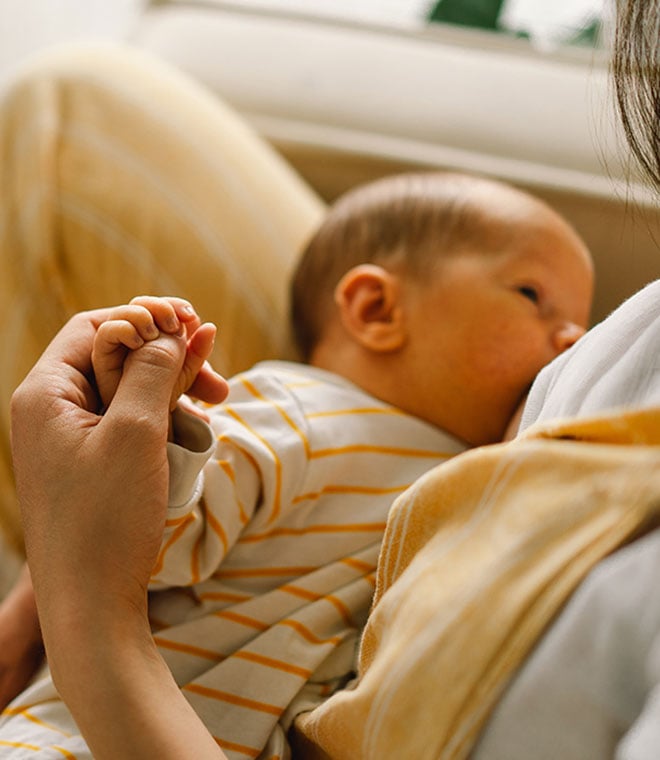 White woman breastfeeding infant