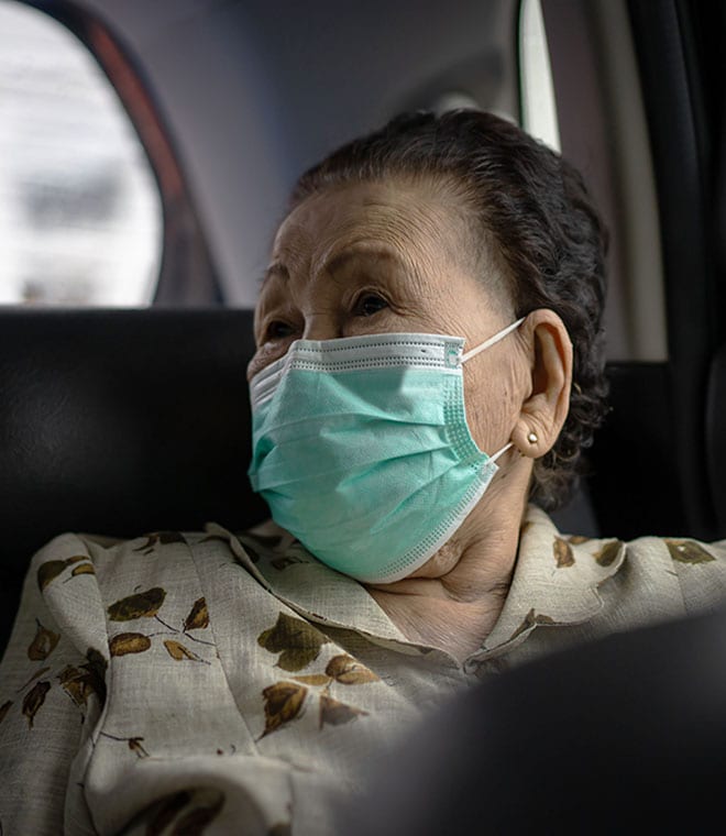 Older Asian woman wearing a mask