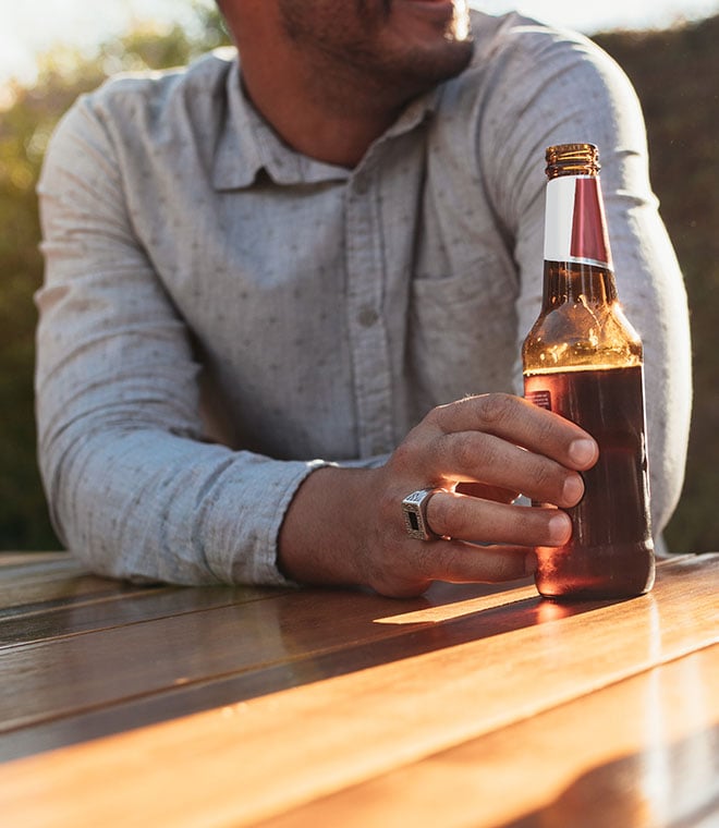 Man holding a bottle of beer