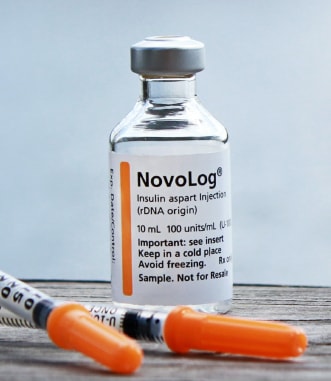 Close up insulin and orange needle
