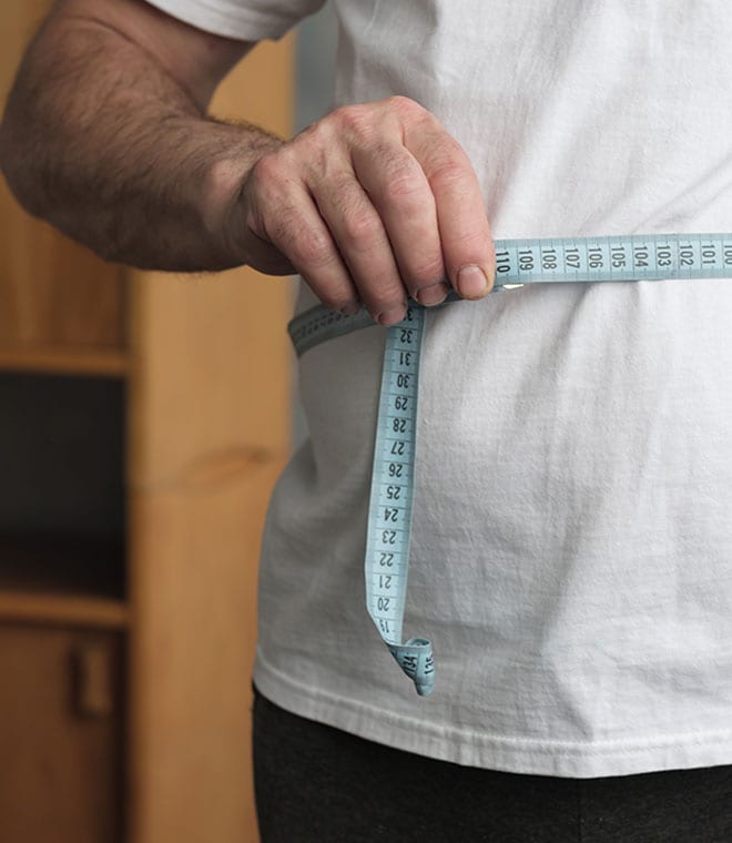Man measuring his stomach