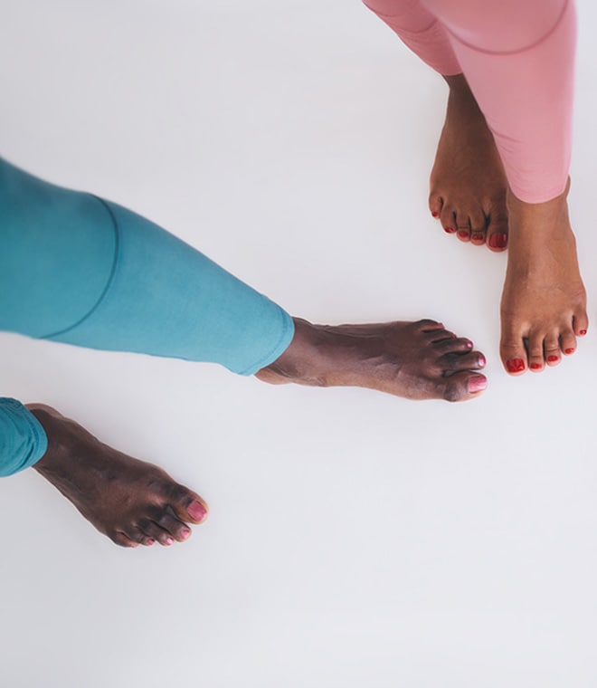 Two black women with painted toenails