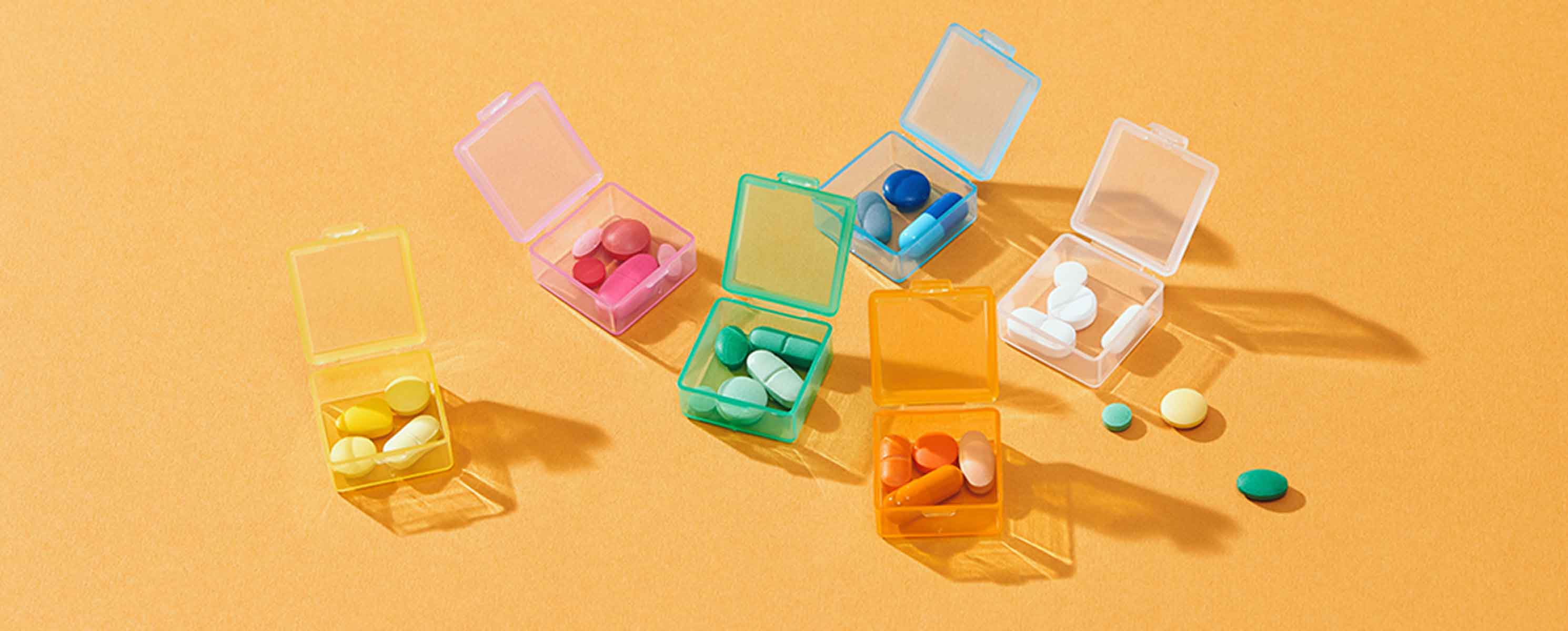 Colorful pills on a yellow background