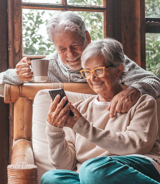 Older couple looking at phone and smiling