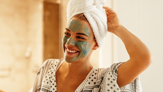 Woman smiling with a face mask on