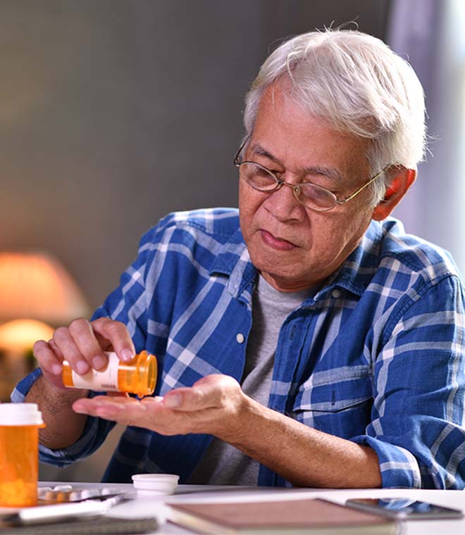Older white man taking medication