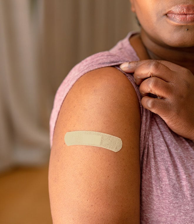 Black woman with a band-aid on her arm