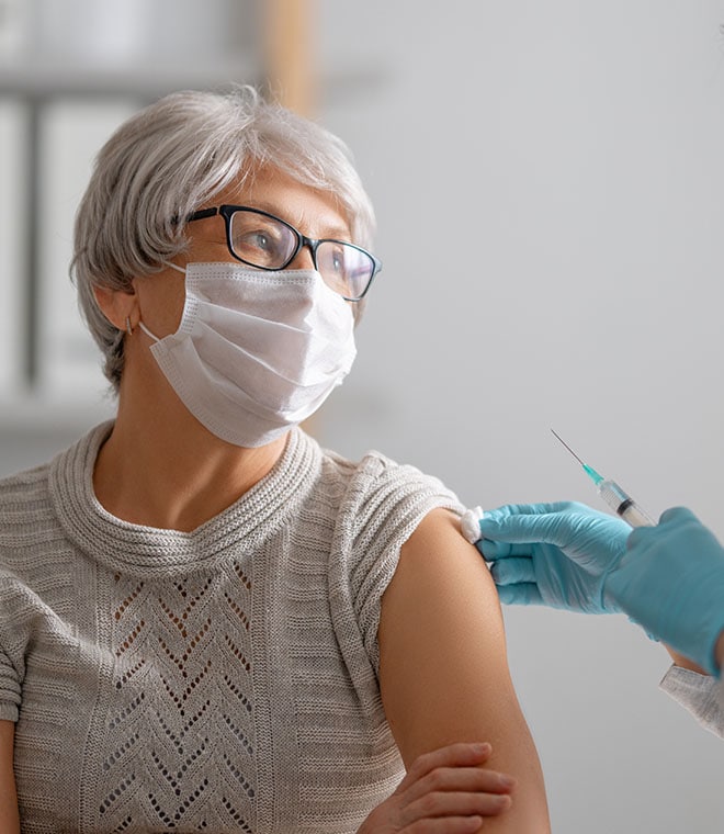 Elderly white woman getting a vaccine