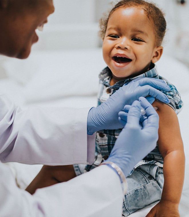 Black toddler receiving a vaccine