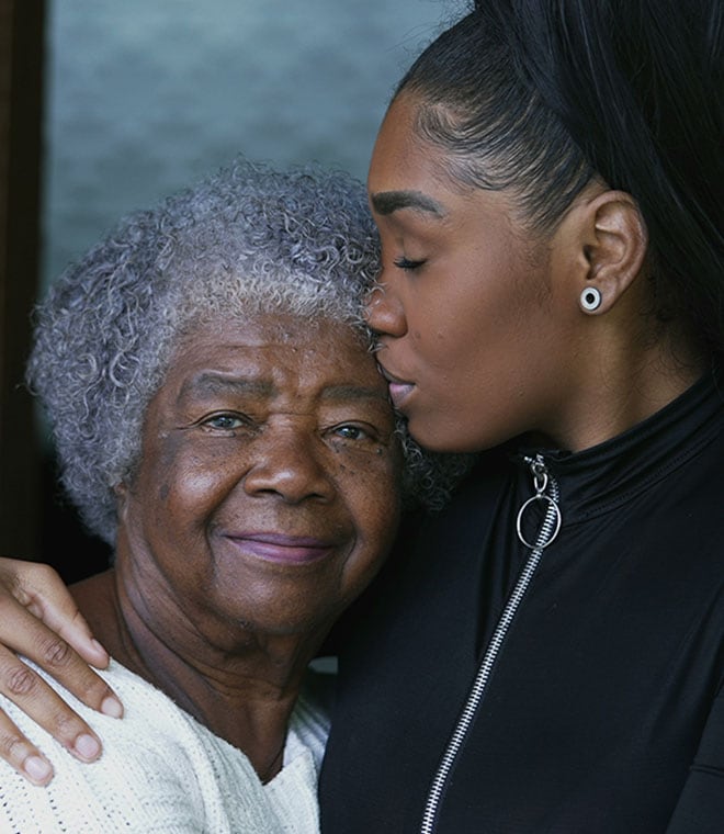 Older and younger black women hugging