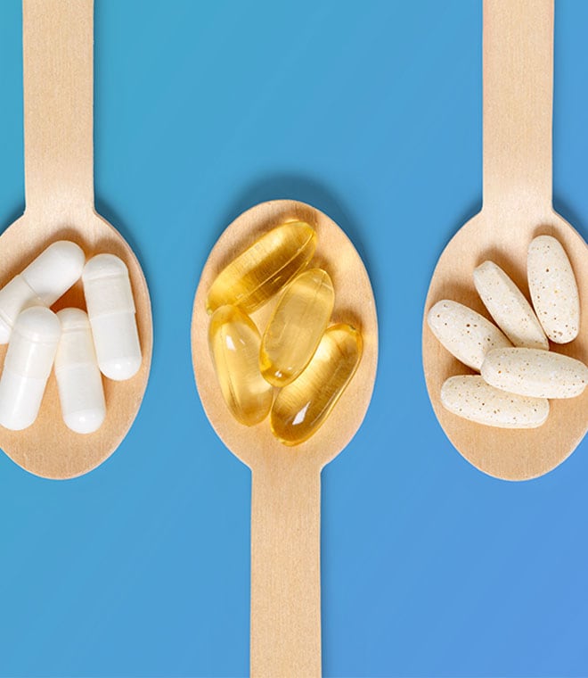 Three wooden spoons with vitamins