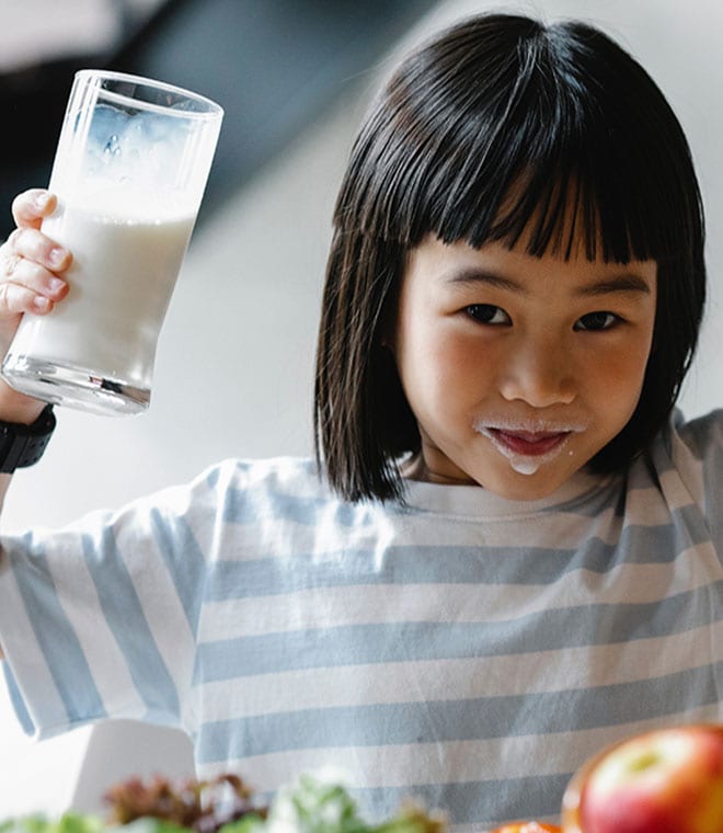 Young Asian girl drinking milk