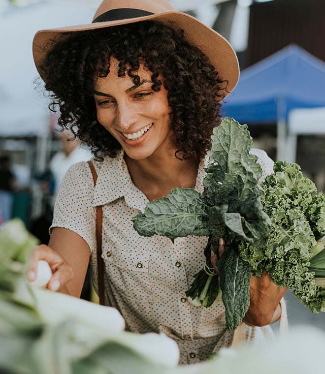 Young women in a hat at the farmers market