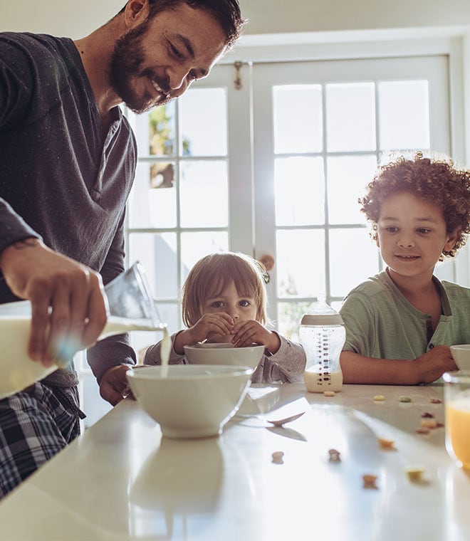 Young family pouring a bowl of cereal 