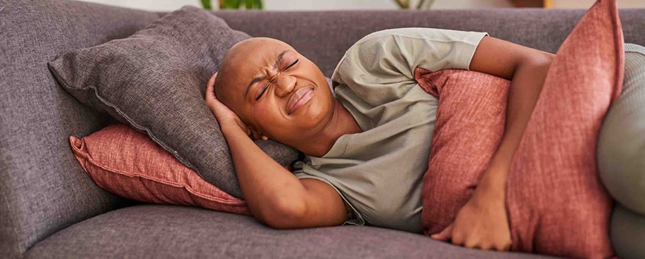 Black woman laying on couch
