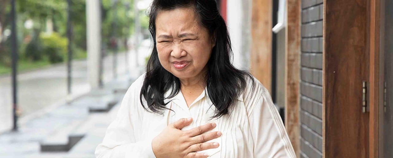 Asian woman holding her chest