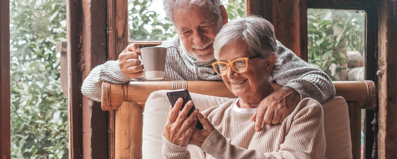 Older couple looking at phone and smiling