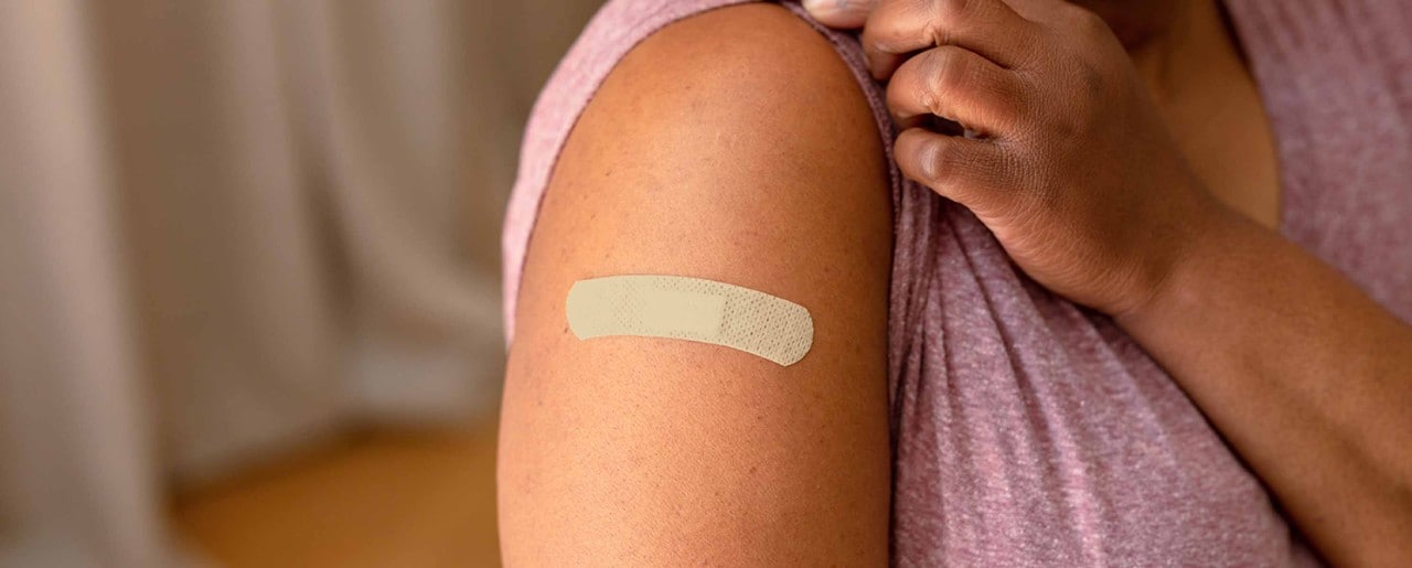 Black woman with a band-aid on her arm
