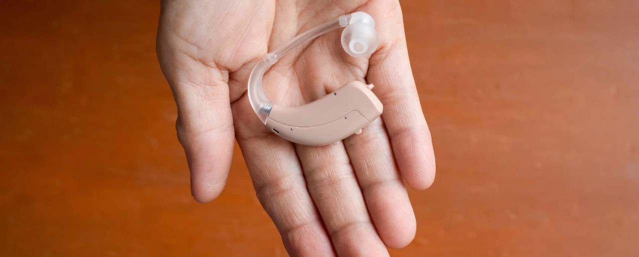Hand holding a hearing aid
