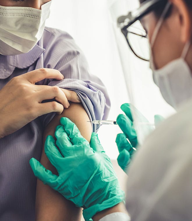 Young white woman getting a tetanus shot in arm